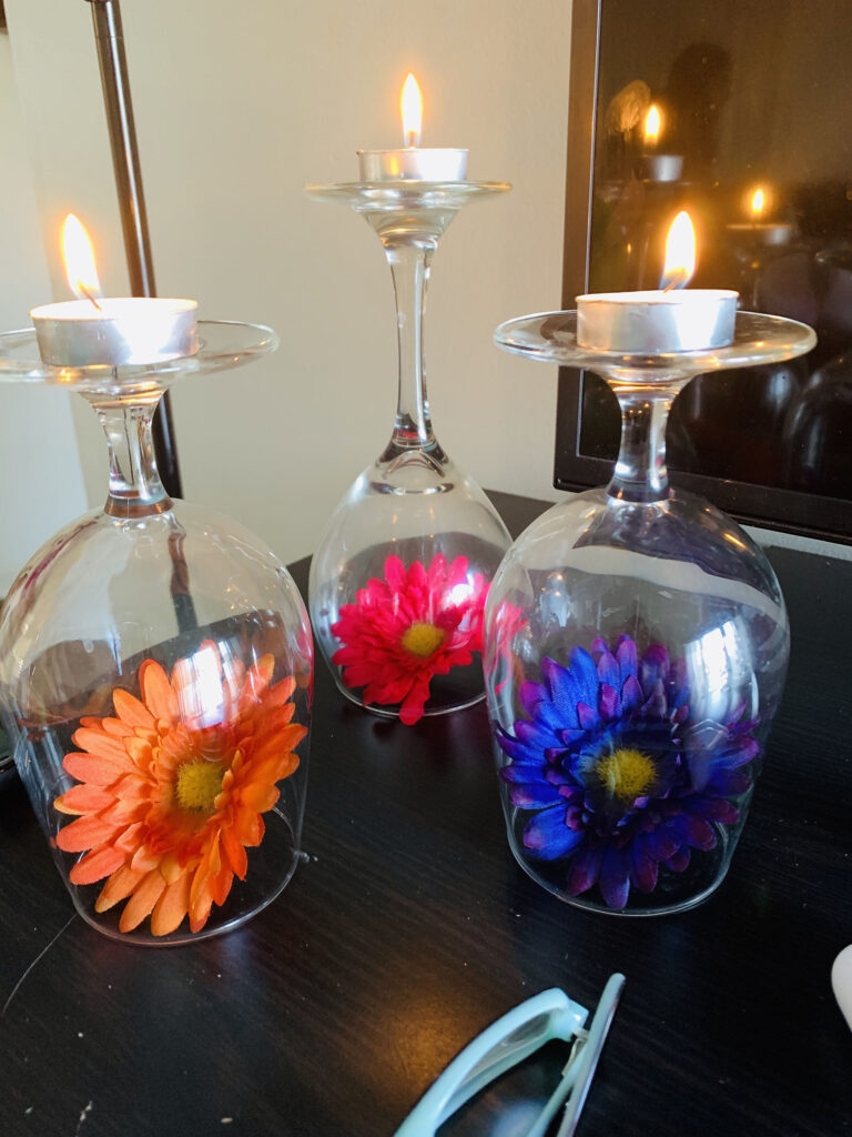 Wax divas/candle placed on wine glasses Wax divas/candle placed on wine glasses ,a decoration idea I learned recently.